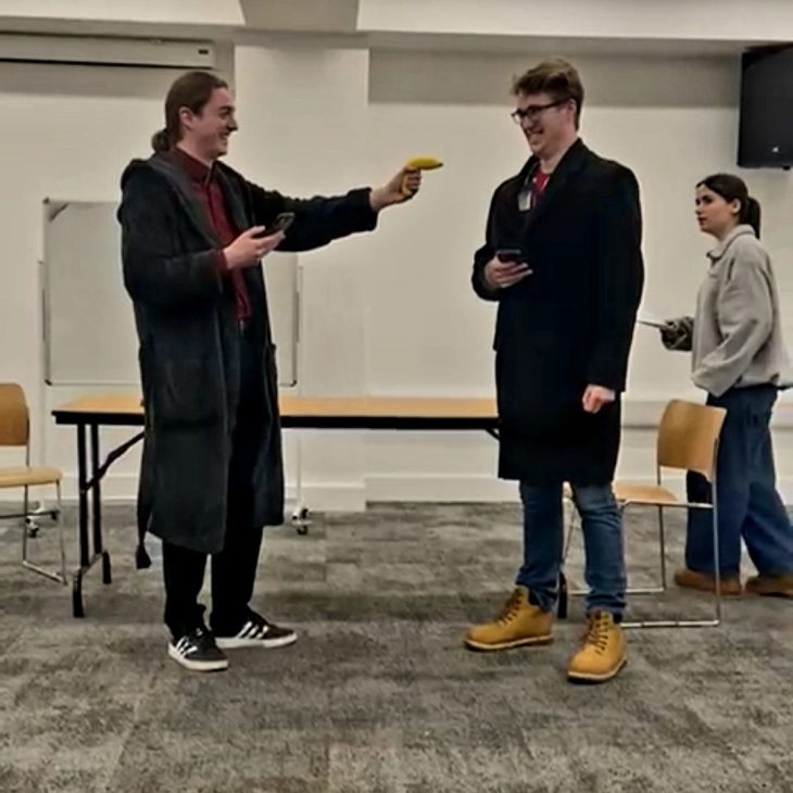 A production image from Sherlock Holmes, showing one man pointing a gun at the other.